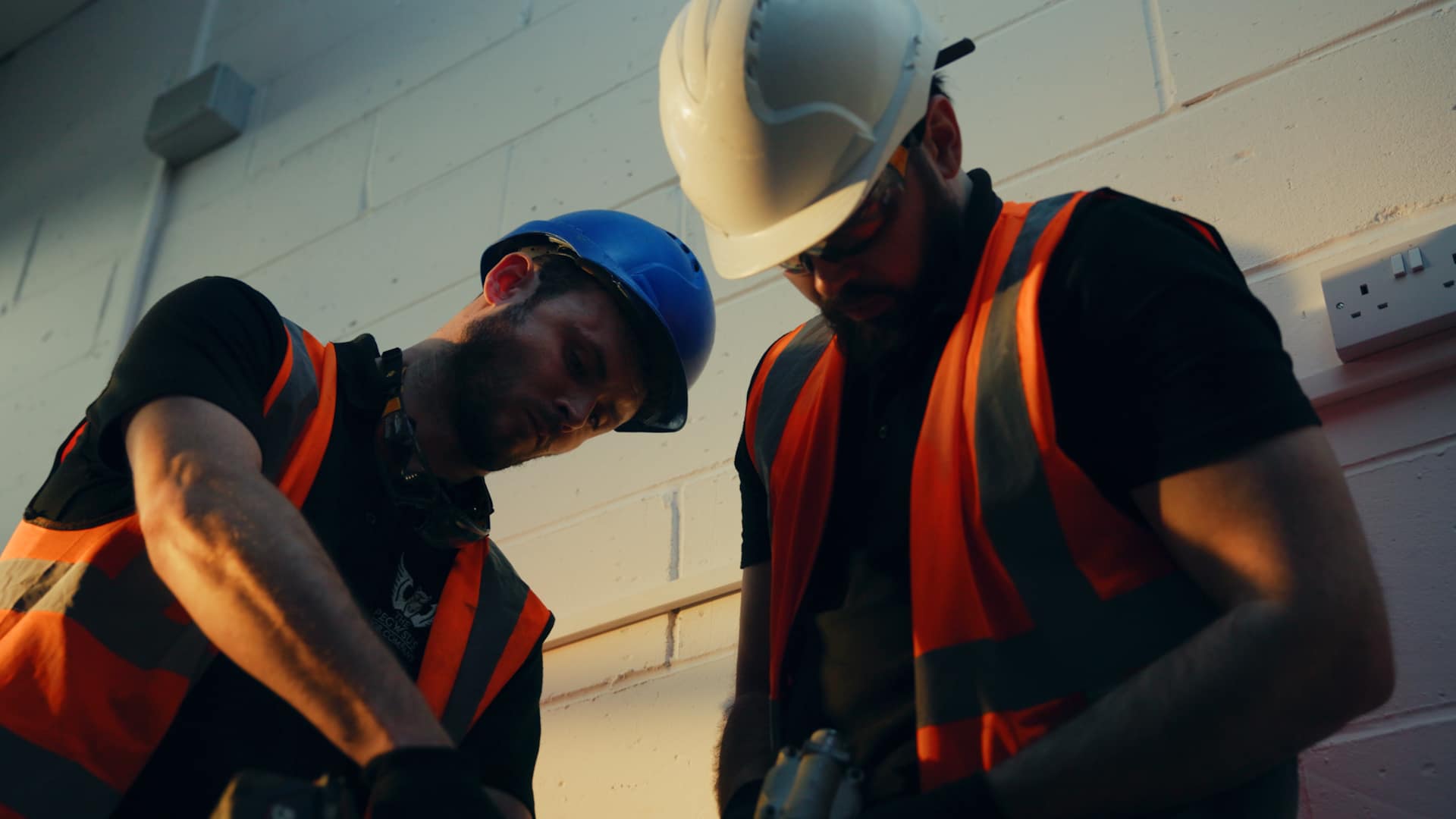 Two engineers working in high vis