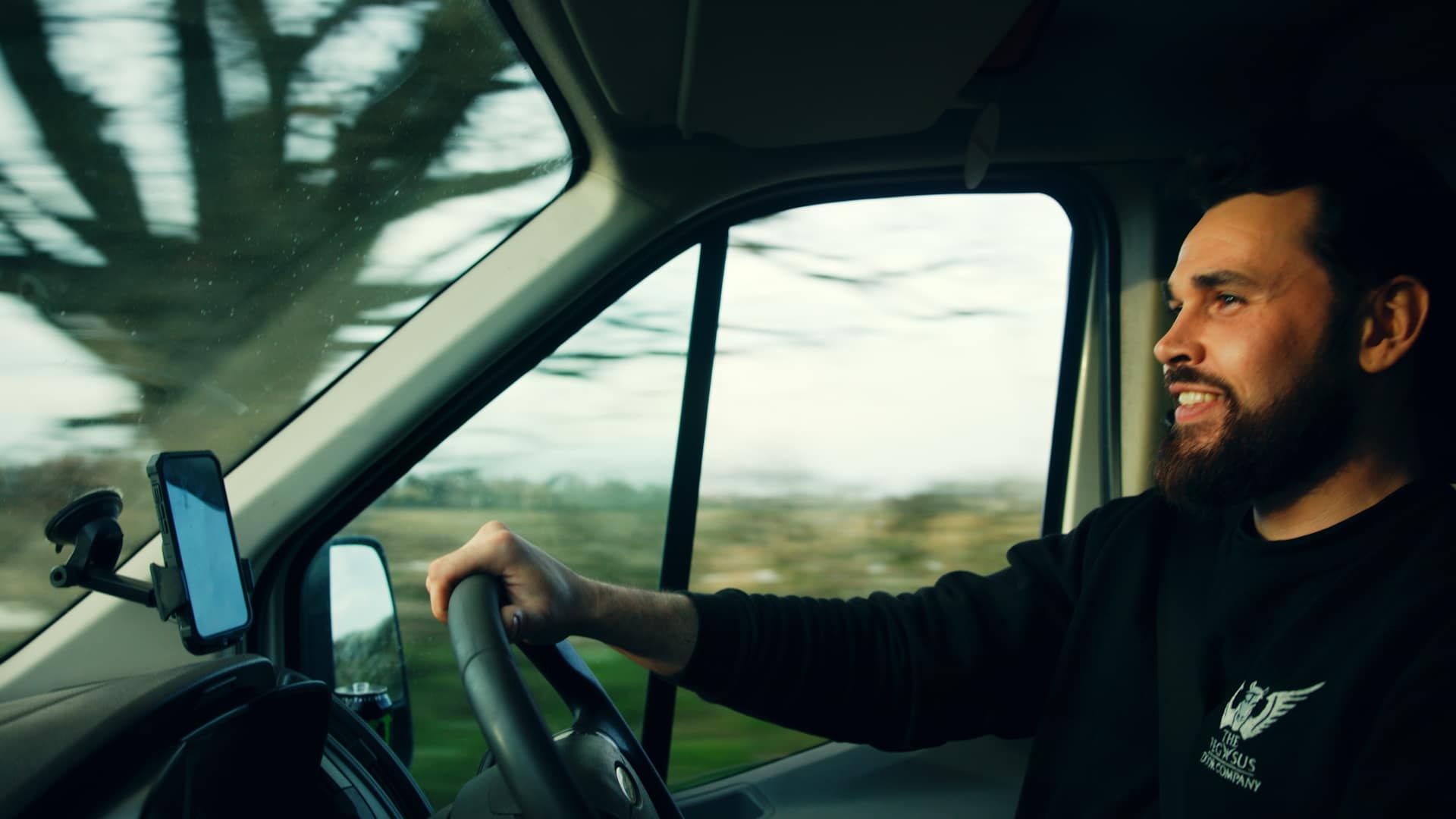 Workman driving a van on a country lane